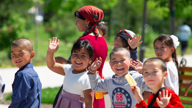 Smiling and waving kids form Central Asia 