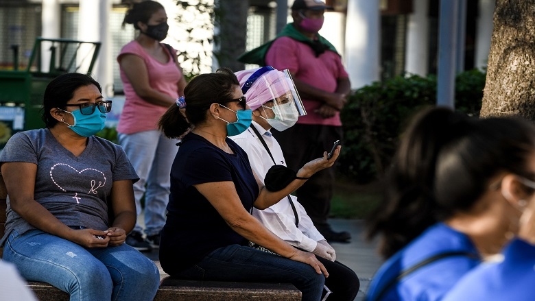 Women wearing masks in a waiting room 