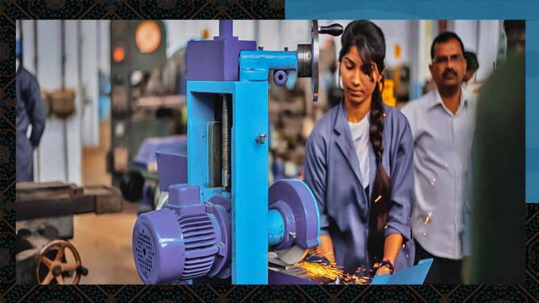 A young South Asian woman working in industrial 