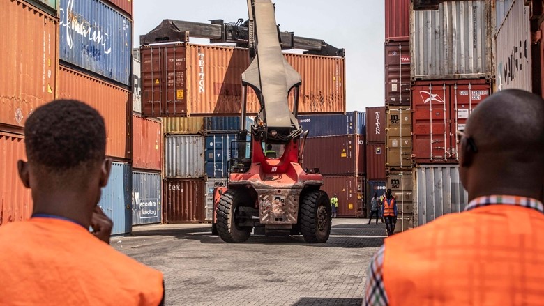 Two people looking at shipping containers