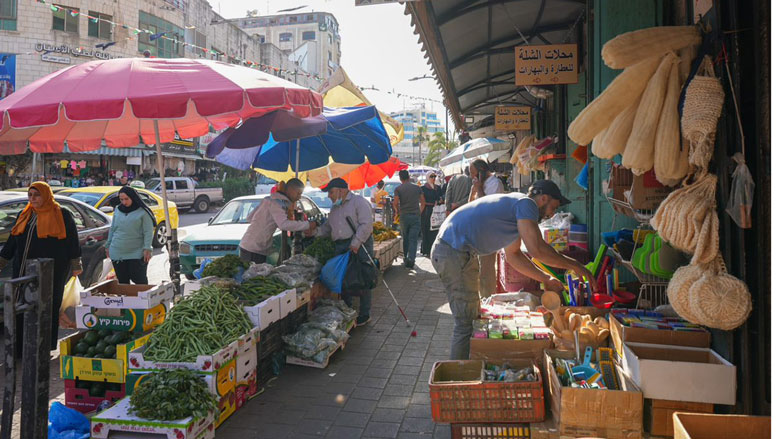 A Palestinian man organizing his store in one of the main markets in Ramallah