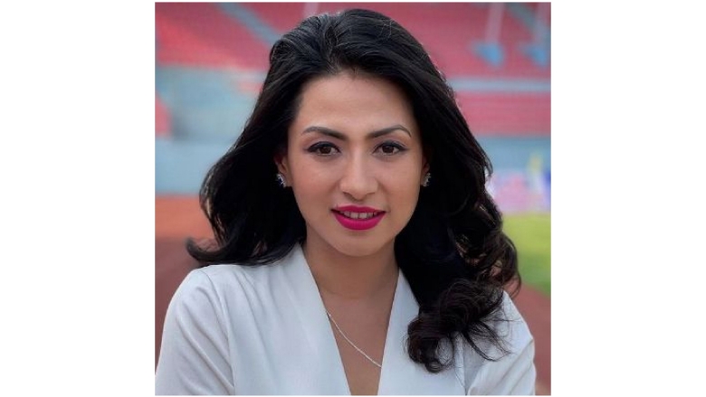 Female with black hair wearing white blouse