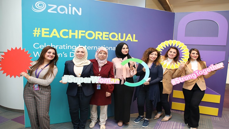 Business women in Iraq showing signs with gender equality messaging