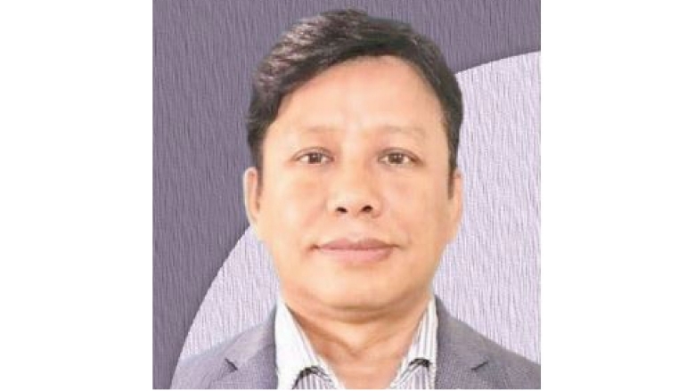 Male with black hair, wearing dark grey blazer and light grey blouse