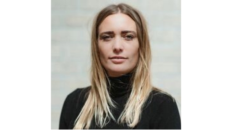 Female with long blond hair wearing black turtle neck 