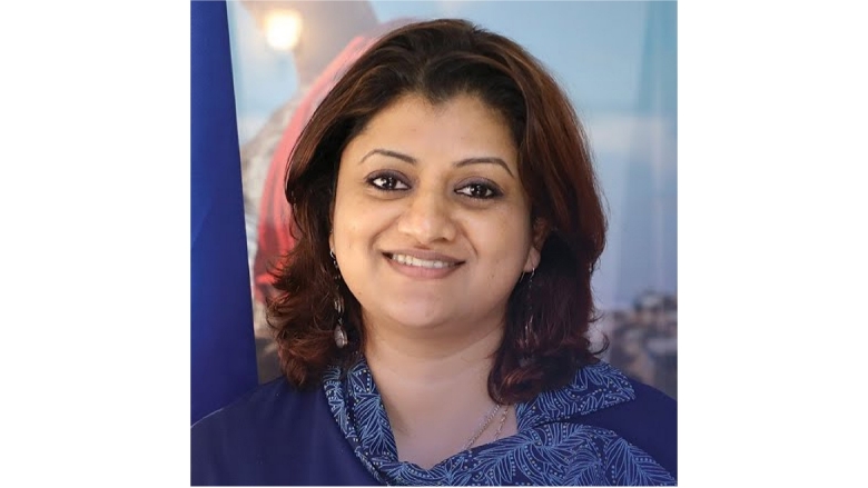 Female with brown short hair wearing blue blouse