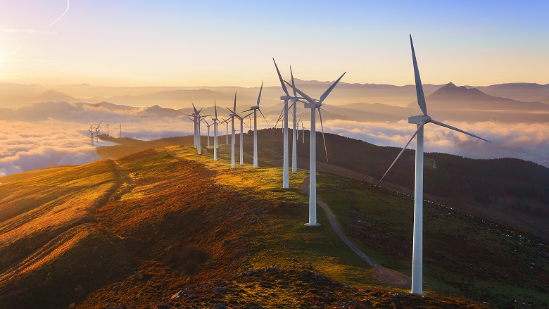 Wind turbines lined up at the top of a mountain 