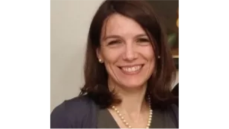 Female with short brown hair, wearing brown blouse