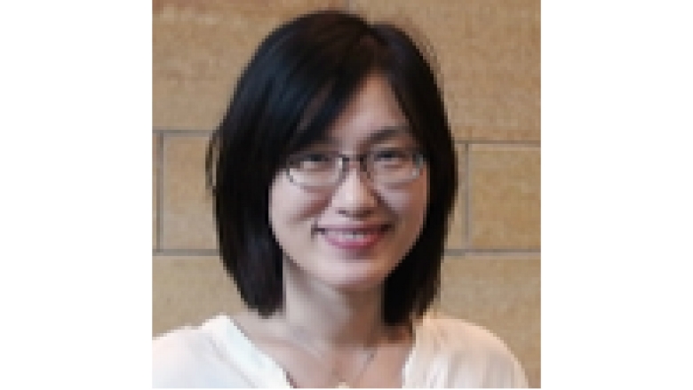 Female with short black hair, wearing white blouse and eyeglasses