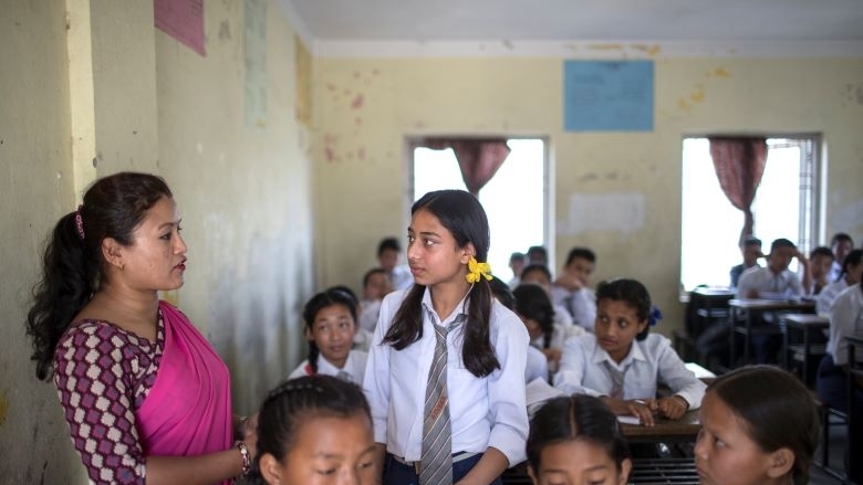 Students and a teacher in a classroom in Nepal
