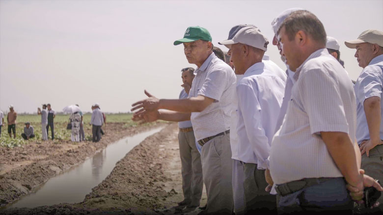 Farmers by a canal