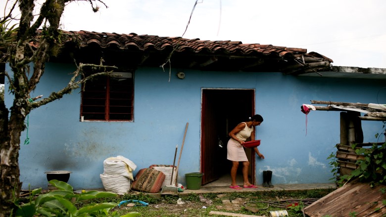 A woman outside her home