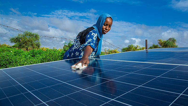 Woman cleaning a solar energy panel in Mauritania