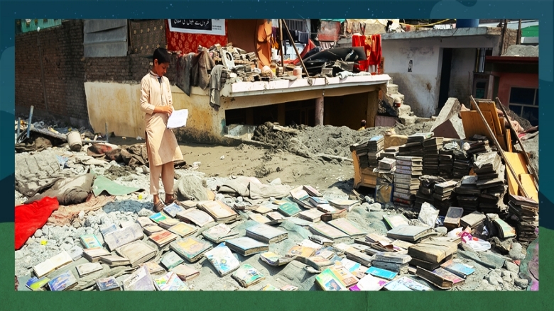 People salvage usable items from damaged homes caused by floodwaters in Swat Valley, Pakistan