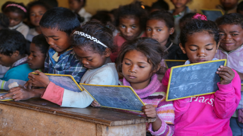 Children in a crowded classroom in a low income country