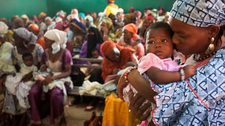 A woman waits to vaccinate her baby at a health clinic in Bamako, Mali. Photo © Dominic Chavez/World Bank