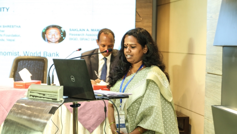 Female speaker on the podium wearing traditional Indian clothes