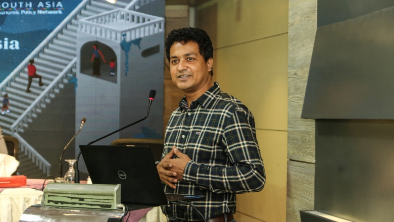 Male speaker on the podium wearing blouse