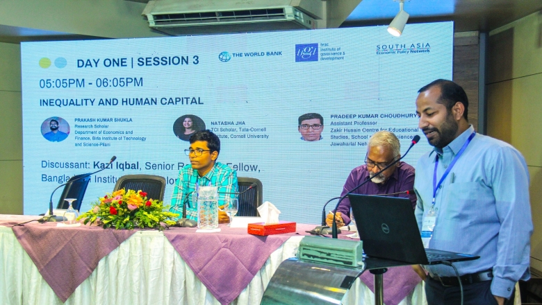 Male speaker on the podium wearing power blue blouse