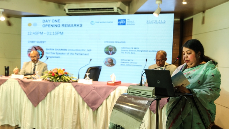 Female speaker on the podium wearing traditional Bangladeshi clothes