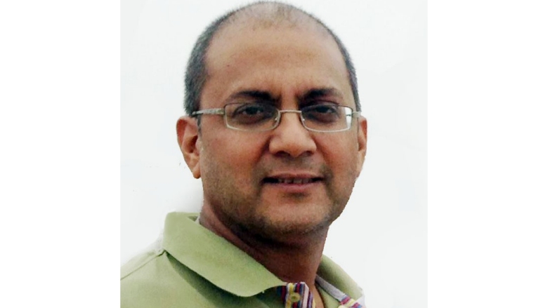 Male wearing eye glasses and green polo shirt