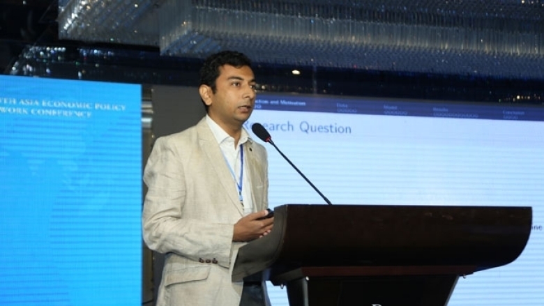 Male in formal attire on the podium