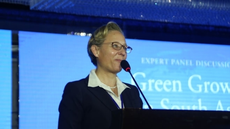 Female in formal attire on the podium