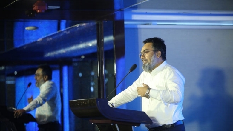 Male in formal attire on the podium