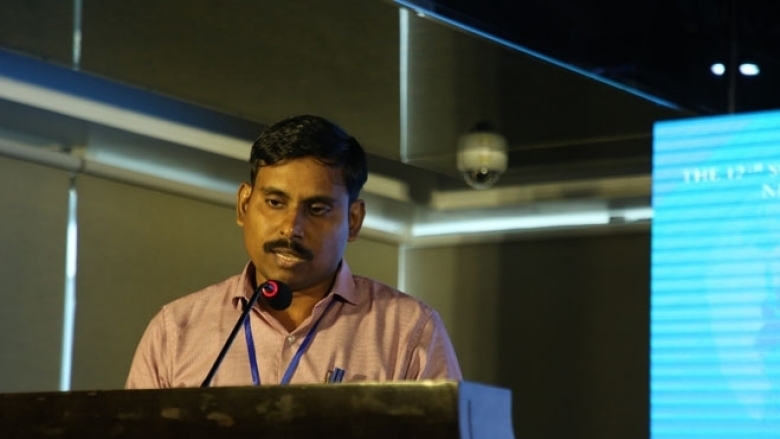 Male in formal attire on the podium