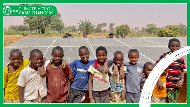 Group of smiley children in front of solar panels in Niger