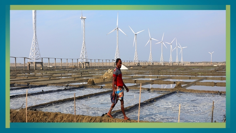 Picture of a man at a wind power mill in Bangladesh
