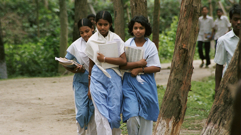 Three girls walk home from school in Bangladesh