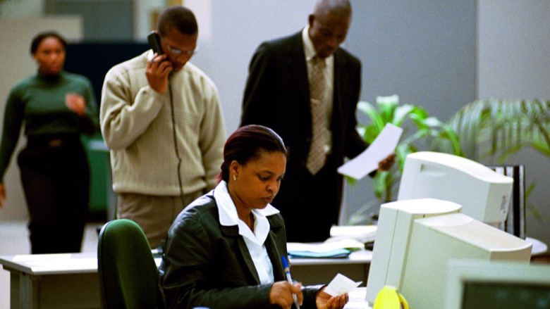 People in a bank looking concerned