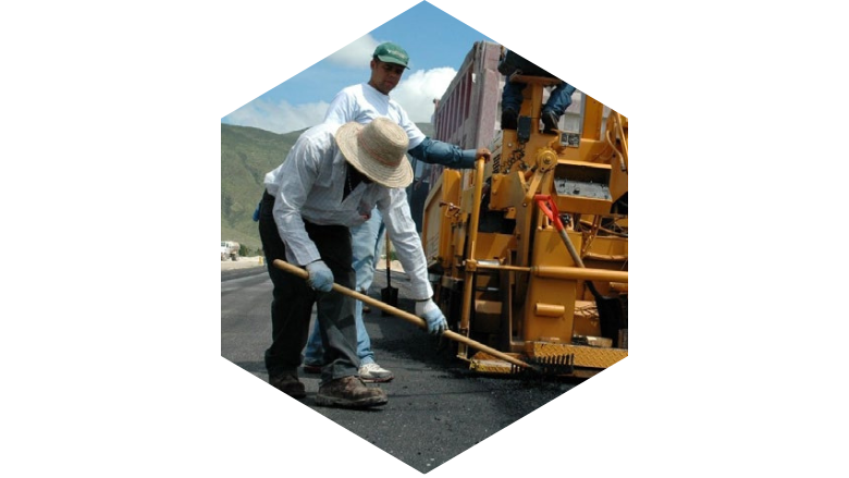 Construction workers in Haiti lay asphalt on a road