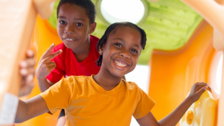 Jamaican boy and girl smiling broadly