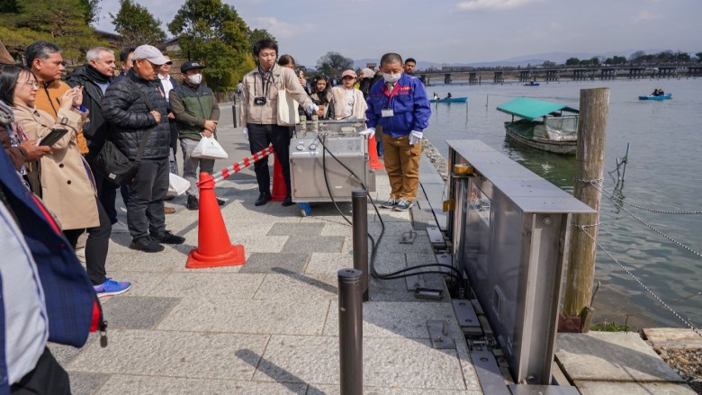 Participants receiving an explanation of retractable watertight walls.