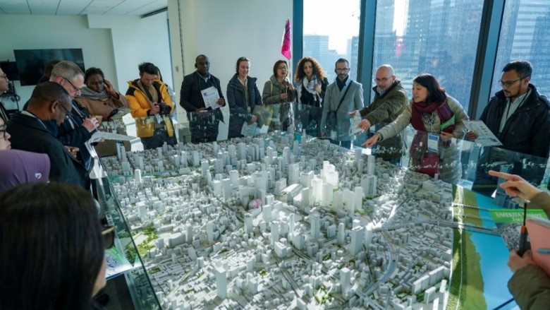 Photo 1. Participants looking over Umekita project model in UR office, Osaka.