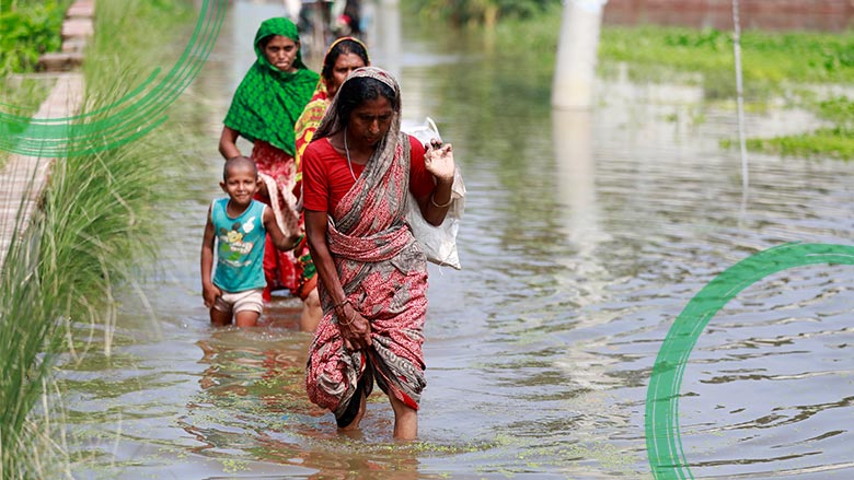 Women walking through a flooded area