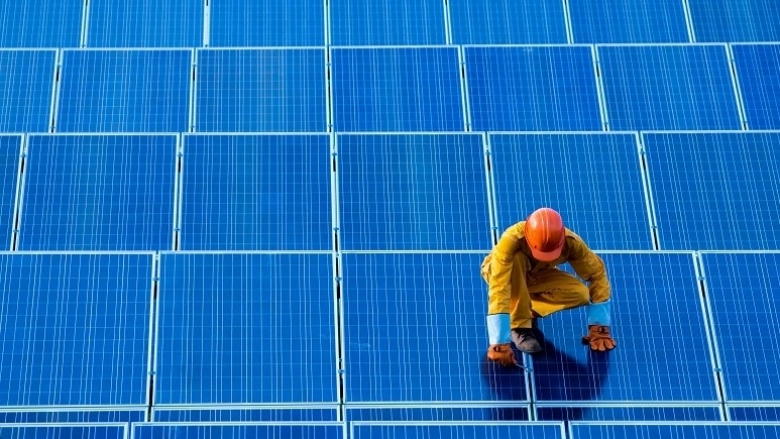 Worker checking solar panels module system