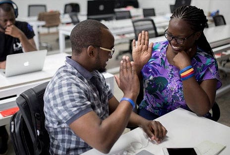 People raising their hand at a conference
